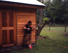 Ann Savoy playing fiddle at home in Eunice